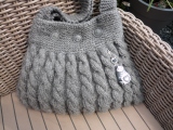 Grey cabled bag complimented